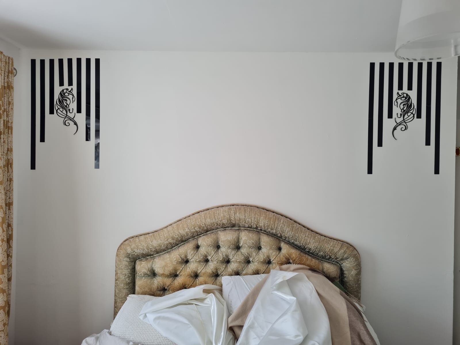 Bedroom with black striped wall art and horse motifs